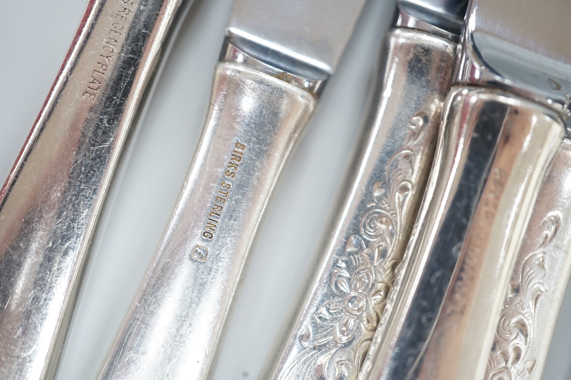Five Canadian Birks sterling table forks, one sterling teaspoon and six sterling handled table knives, together with seven items of sterling flatware, a Hanau white metal ornate spoon and fifteen items of Birks Regency p